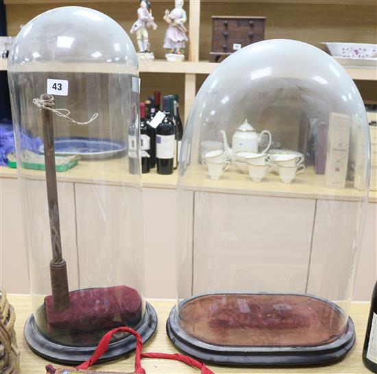 Two glass domes with stands